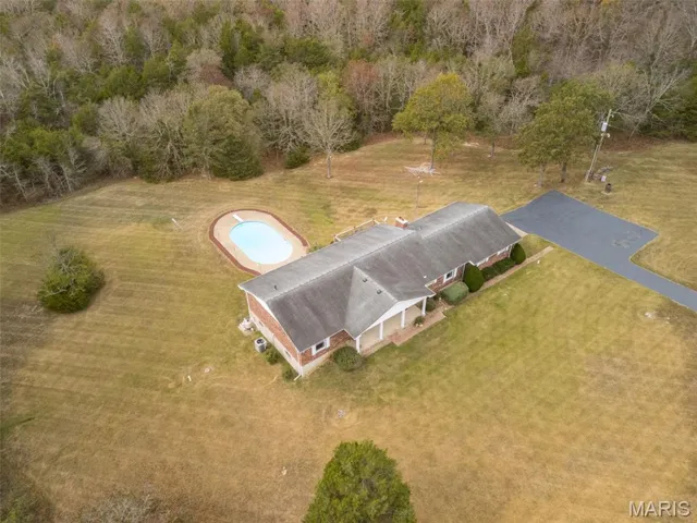 Aerial view of property and surrounding area with a pool area