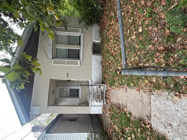 Property entrance featuring brick siding