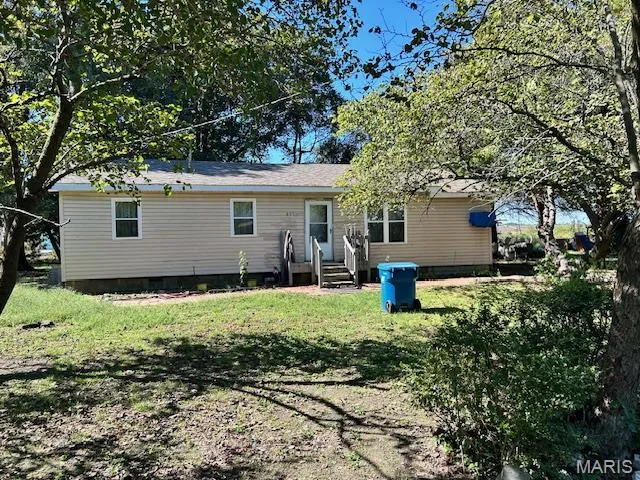 Back of property featuring crawl space, a yard, and entry steps