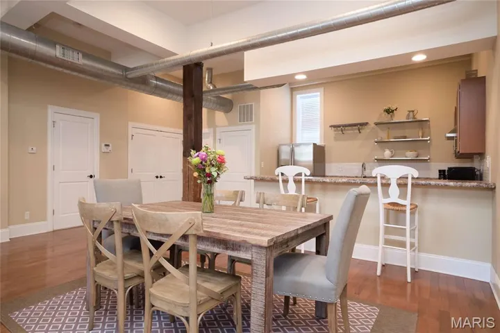 Dining room featuring dark wood-type flooring and recessed lighting