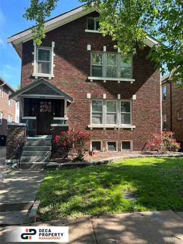 View of front of home featuring brick siding and a front lawn