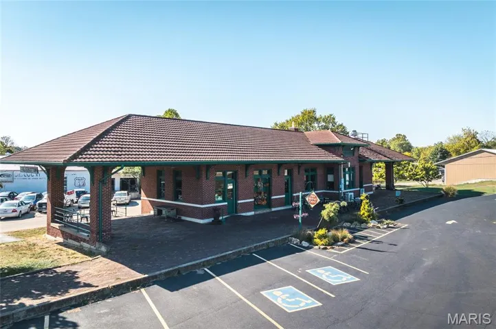 View of building exterior featuring uncovered parking