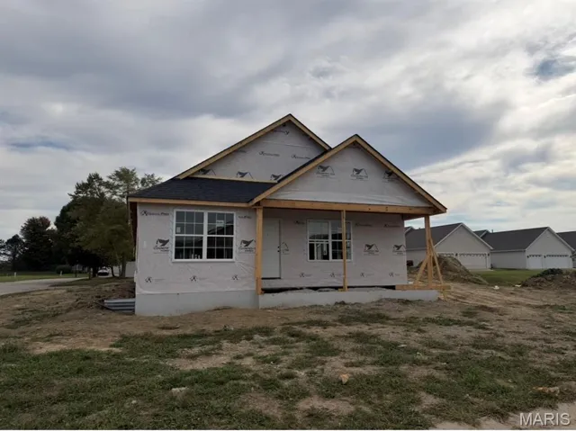 Property in mid-construction with roof with shingles and a front lawn