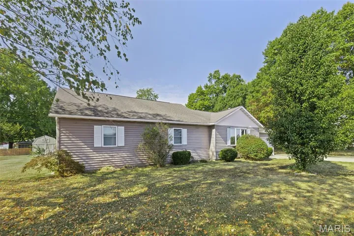 Single story home with a front yard and roof with shingles