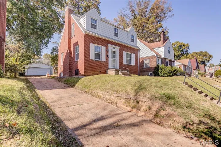View of front of property featuring a front lawn with plenty of space for parking