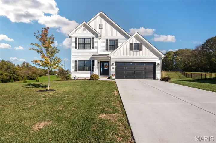 View of front of house featuring board and batten siding and driveway