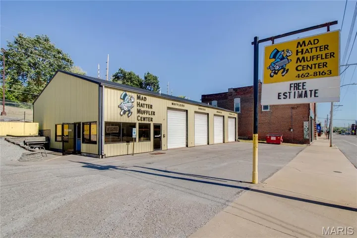 View of commercial property featuring community garages