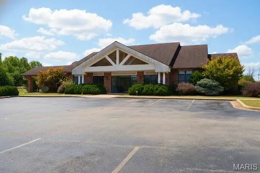 View of property featuring uncovered parking