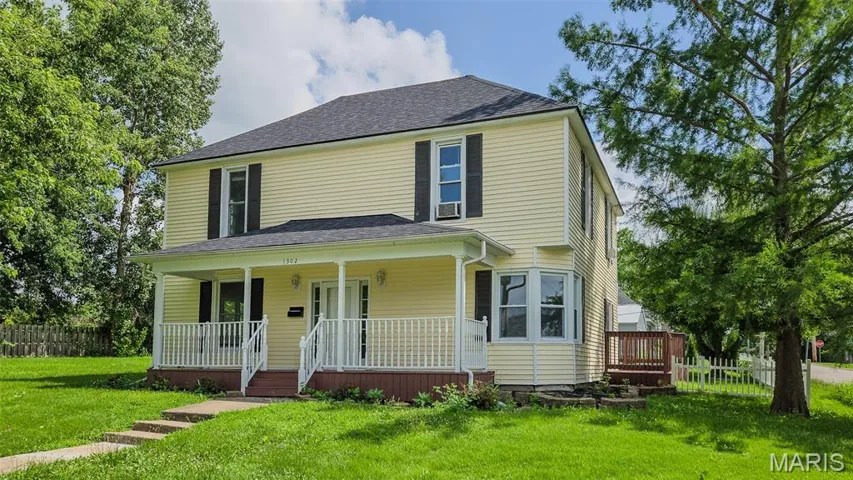 View of front of property featuring covered porch and a shingled roof