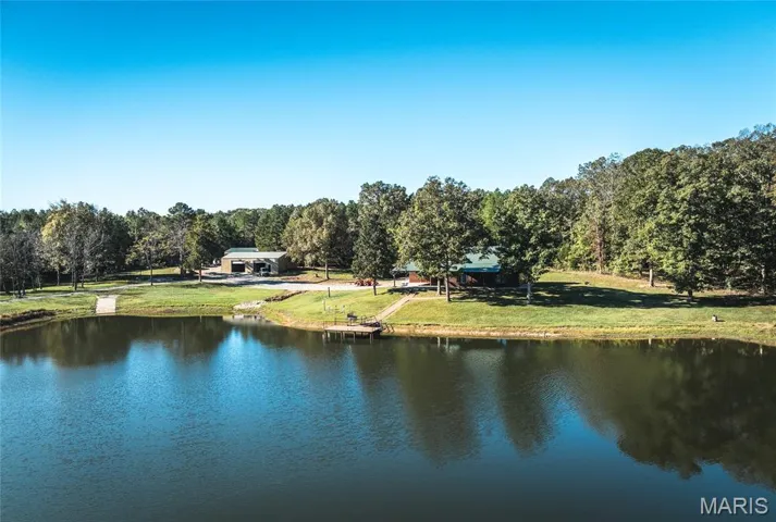 Water view with a heavily wooded area