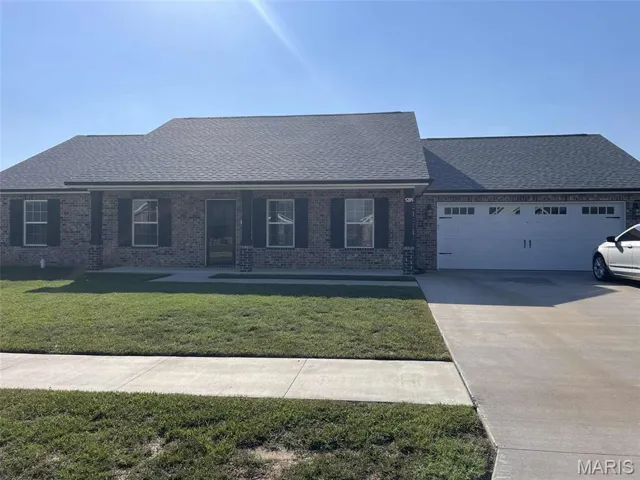 Ranch-style house with covered porch, brick siding, roof with shingles, concrete driveway, and a front yard