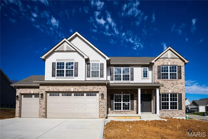 View of front of property featuring brick siding, a porch, driveway, and an attached garage