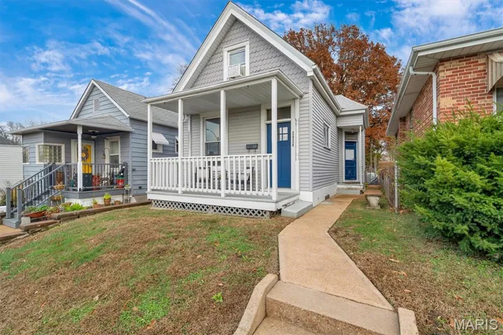 View of front of property with front lawn and covered porch
