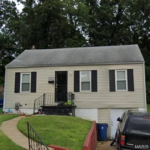 View of front of property featuring a front yard and a shingled roof