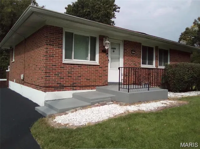 Single story home with brick siding and a porch