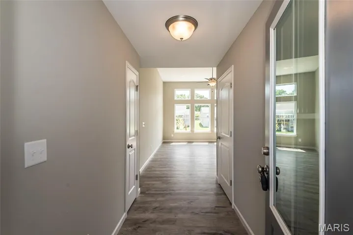 Corridor with baseboards and dark wood-style floors