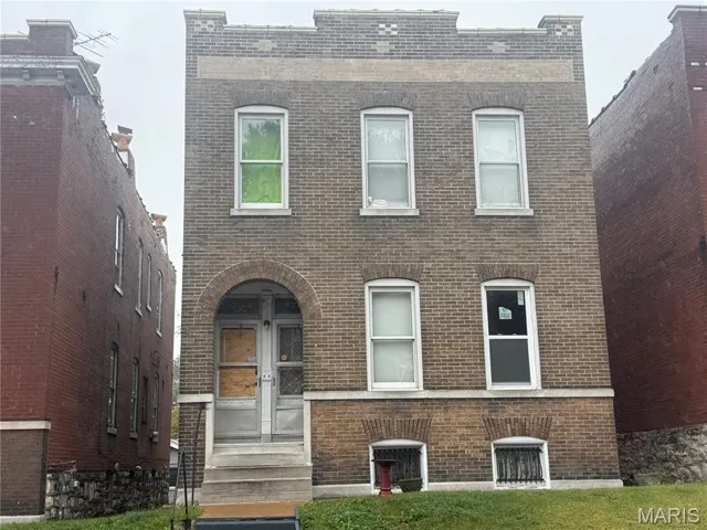 Italianate-style house with brick siding and entry steps