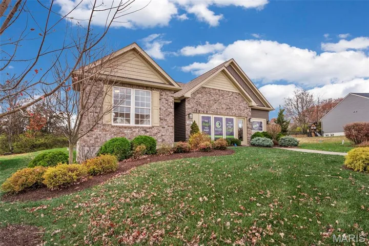 View of front facade with a front lawn and brick siding