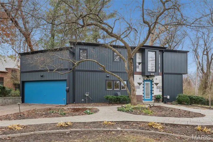 Welcome to 7368 Ahern Avenue, a custom built one-of-a-kind contemporary style home tucked away on a private 1+ acre wooded lot.