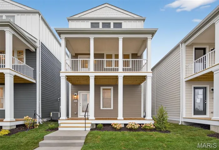 View of front of home with board and batten siding, covered porch, and a balcony