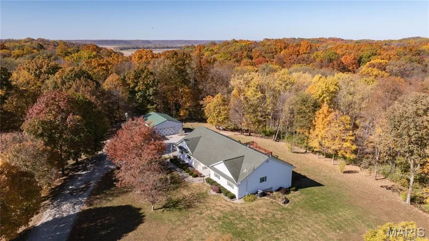 View of subject property featuring a heavily wooded area