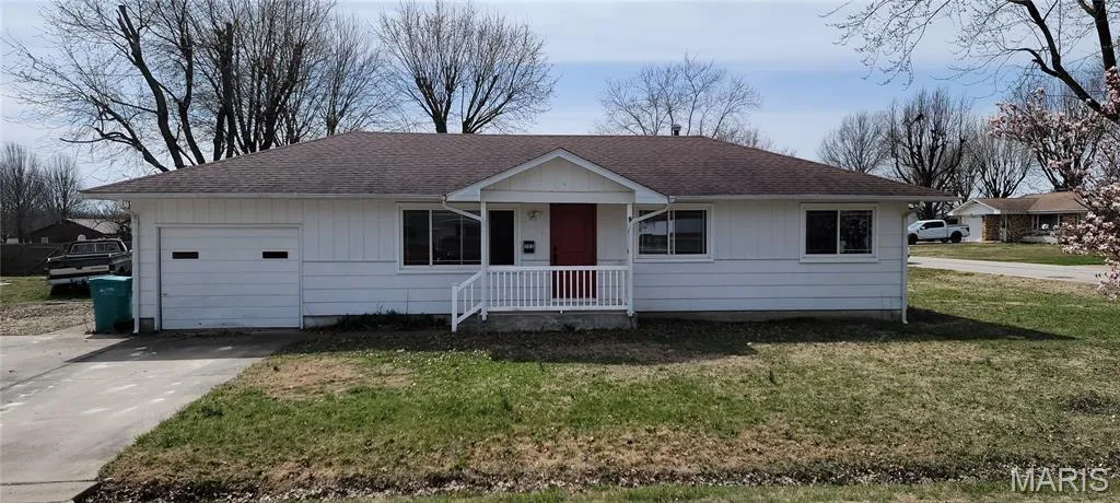 Ranch-style home with roof with shingles, a front lawn, concrete driveway, a porch, and a garage