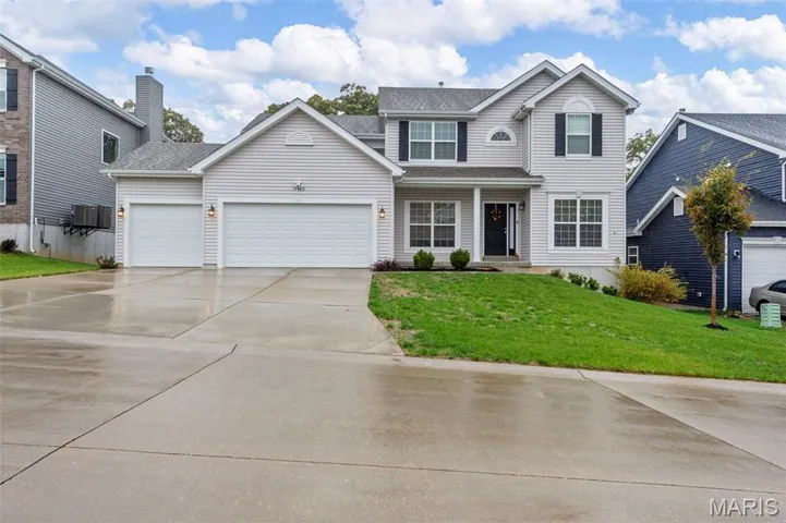 Traditional home with driveway, a front lawn, a garage, a porch, and a shingled roof