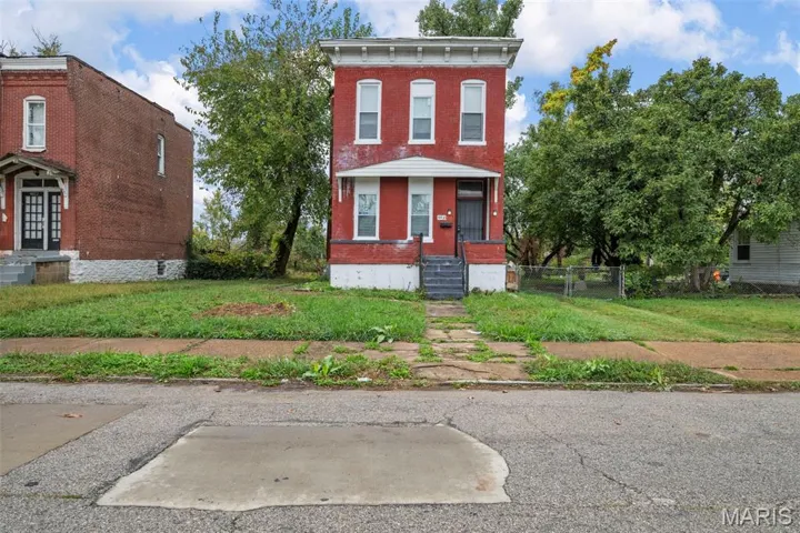 Italianate house featuring brick siding