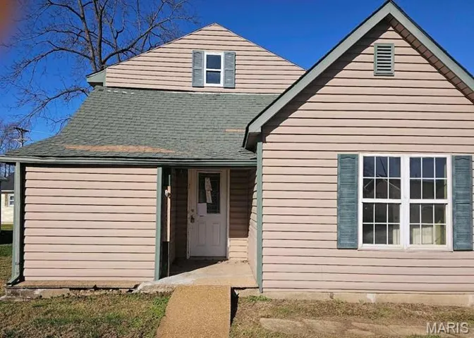 View of front of house featuring a shingled roof