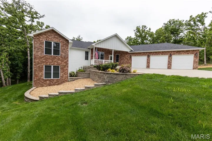 Ranch-style house with covered porch, a front lawn, brick siding, and concrete driveway