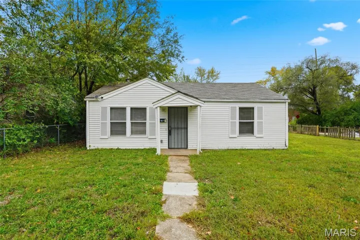 Bungalow featuring roof with shingles