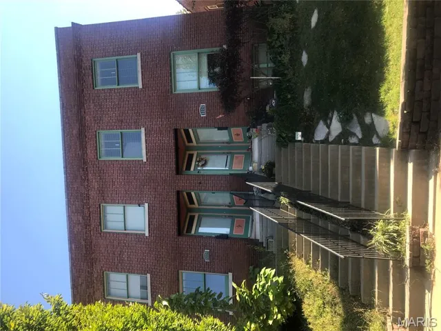 Traditional-style house with brick siding and stairway