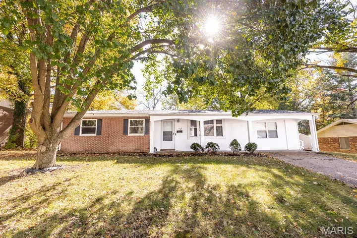 Single story home featuring a front lawn and brick siding