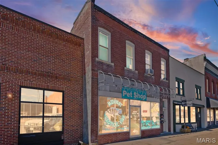 View of property at dusk