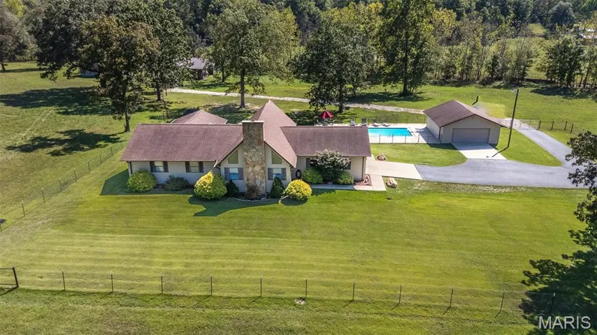 Aerial view of sparsely populated area with a pool area