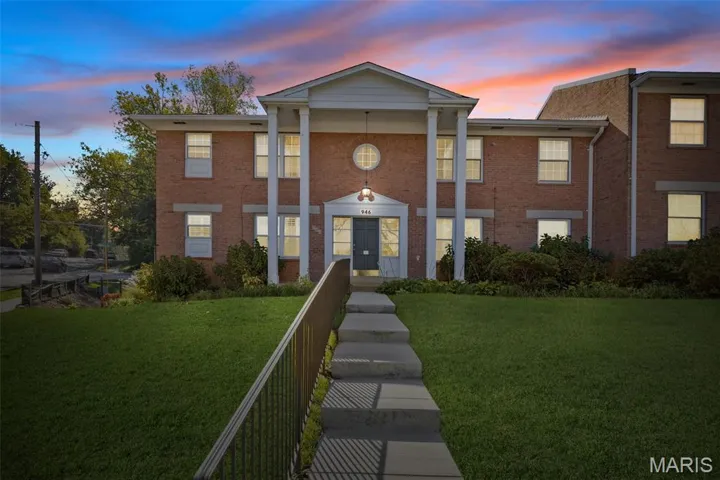View of property at dusk