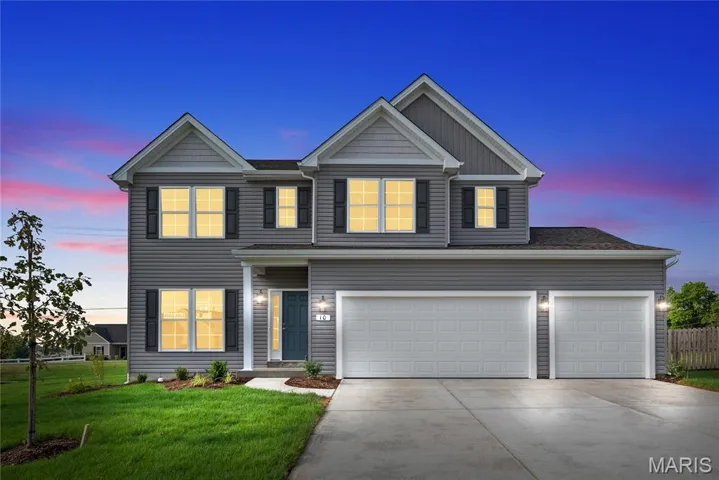 View of front of home featuring driveway, an attached garage, and board and batten siding