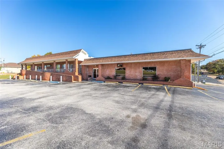 View of property with uncovered parking