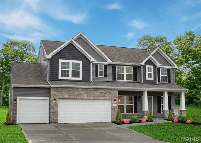 Craftsman-style home featuring a front lawn, board and batten siding, concrete driveway, and stone siding