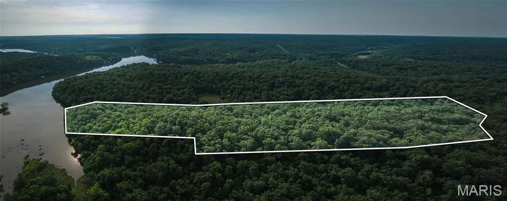 Aerial view of property's location with property boundaries highlighted and a large body of water