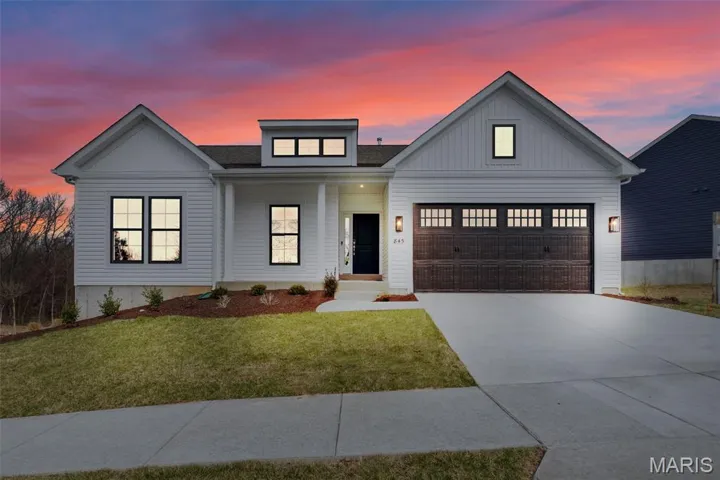 Modern farmhouse featuring a porch, driveway, a front lawn, board and batten siding, and a shingled roof