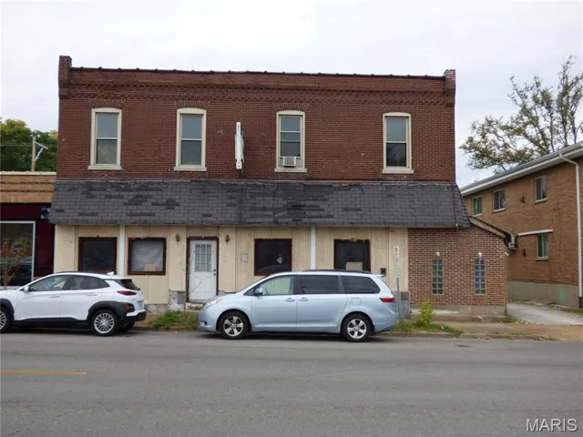Traditional-style house featuring brick siding