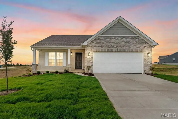 View of front of property with covered porch, concrete driveway, a front yard, an attached garage, and brick siding