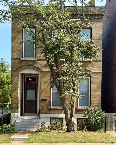 Front view of home and main entry featuring brick exterior.