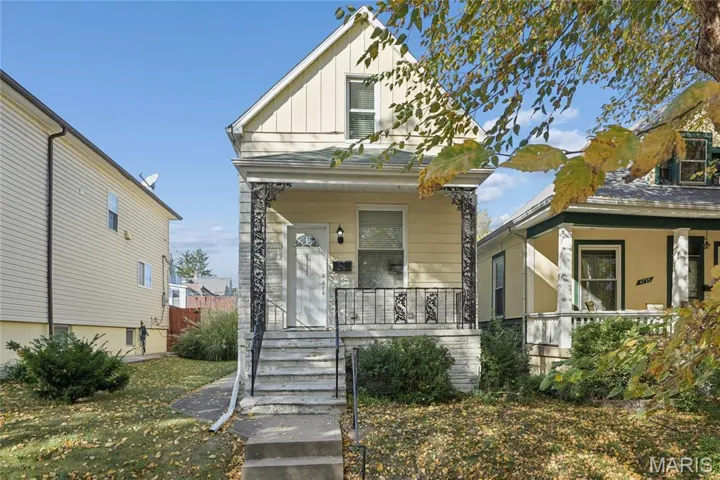 View of front facade with board and batten siding and a porch