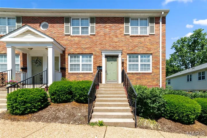 Colonial inspired home with brick siding