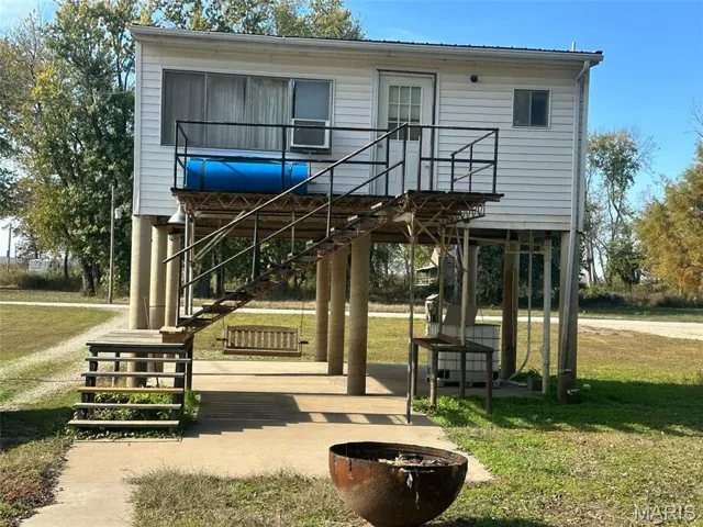 View of home's community with a yard and stairway