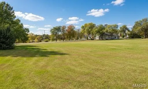 View of property's community featuring a yard