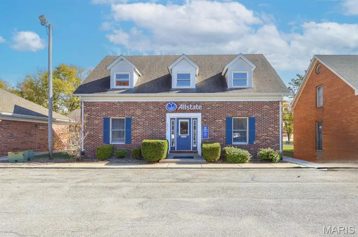 New england style home with brick siding