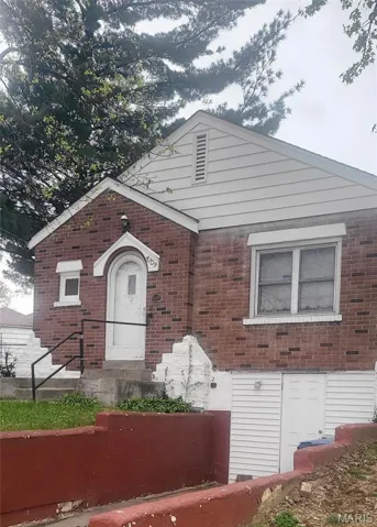 View of front of house featuring brick siding
